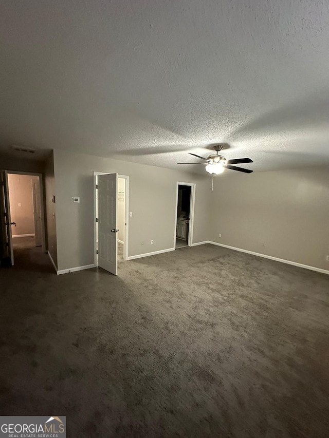 carpeted empty room featuring a textured ceiling and ceiling fan