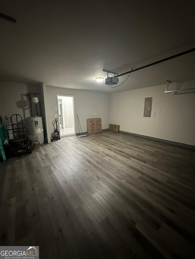 garage featuring electric panel, water heater, and a garage door opener