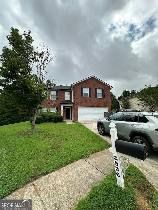 view of front facade with a front yard and a garage