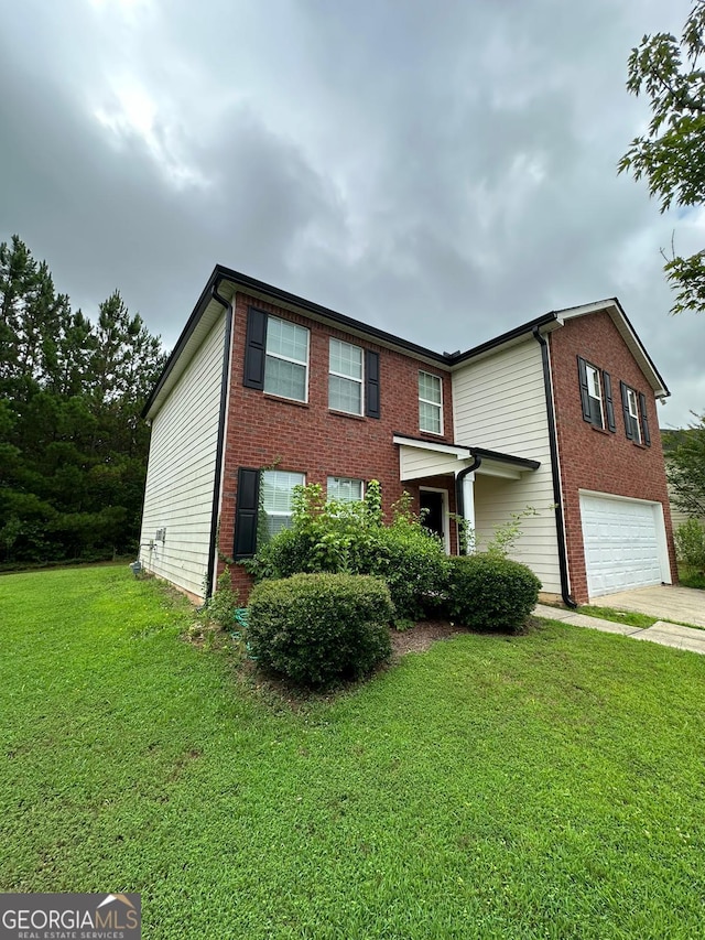 view of front of home with a front yard and a garage