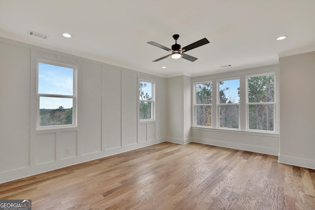 unfurnished room featuring ornamental molding, light hardwood / wood-style floors, and ceiling fan