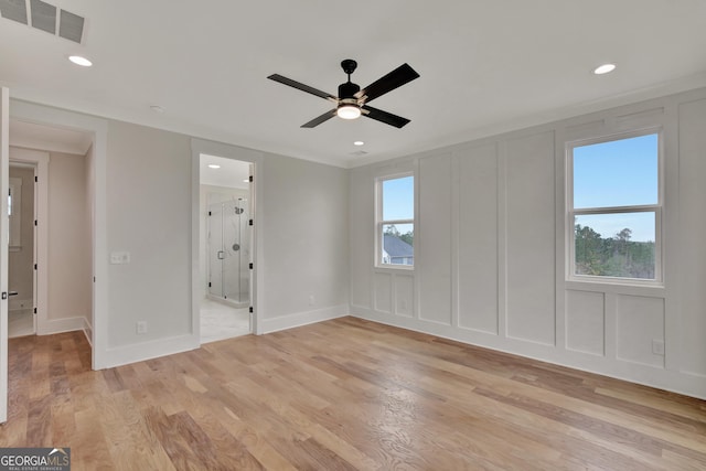 spare room with ceiling fan, ornamental molding, and light hardwood / wood-style floors