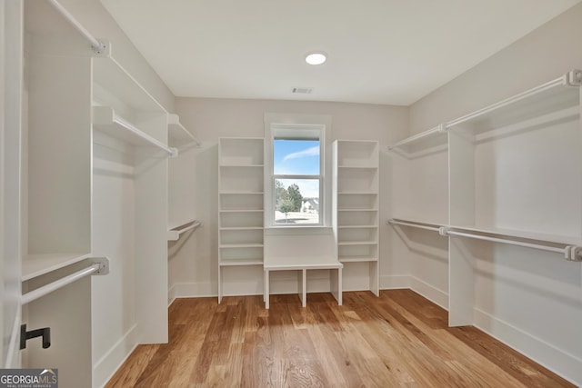 spacious closet featuring hardwood / wood-style floors