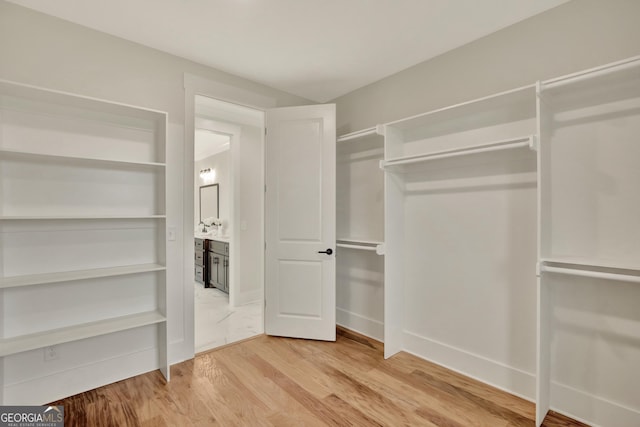 walk in closet featuring hardwood / wood-style flooring