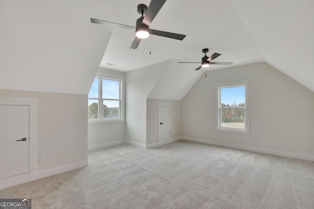 additional living space featuring lofted ceiling and light colored carpet