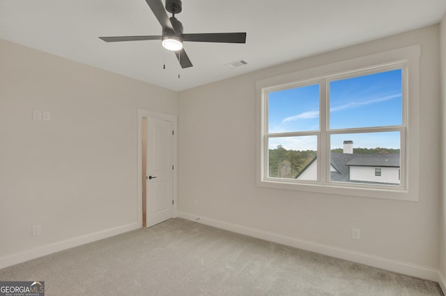 carpeted empty room featuring ceiling fan