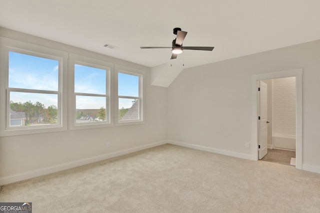 bonus room with lofted ceiling, plenty of natural light, light colored carpet, and ceiling fan