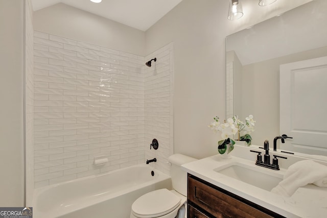 full bathroom with tiled shower / bath, vanity, and toilet