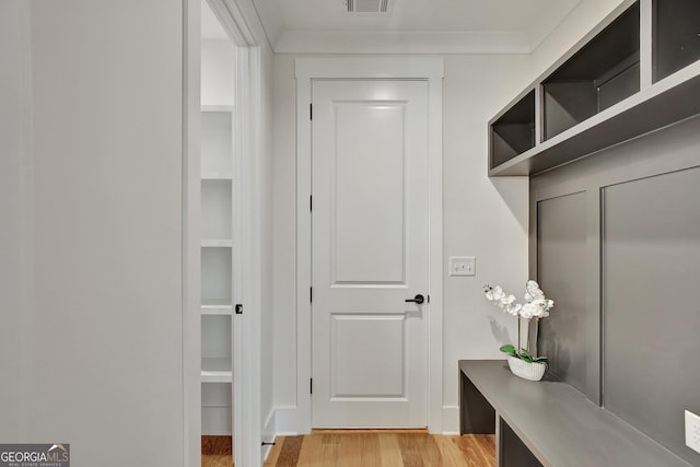 mudroom featuring crown molding and light hardwood / wood-style flooring