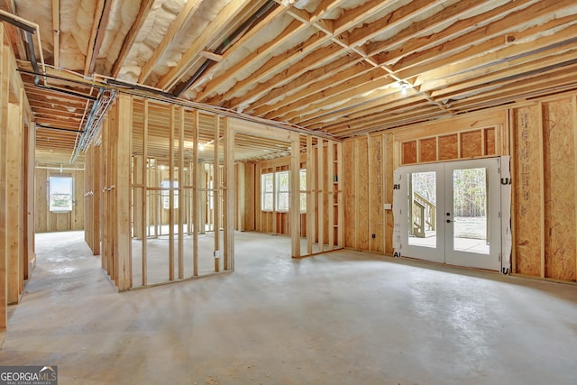 misc room with concrete flooring and french doors