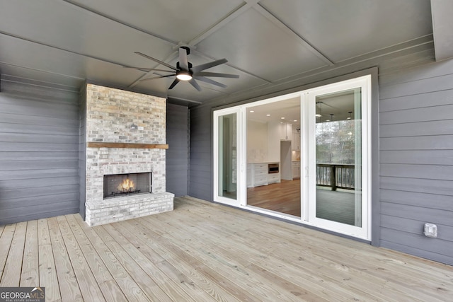 wooden terrace featuring a fireplace and ceiling fan