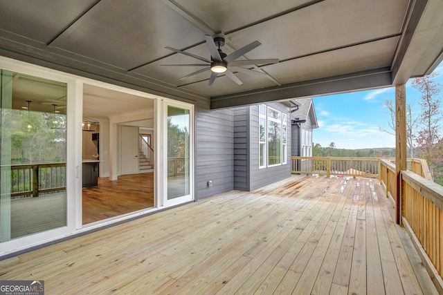 wooden deck featuring ceiling fan