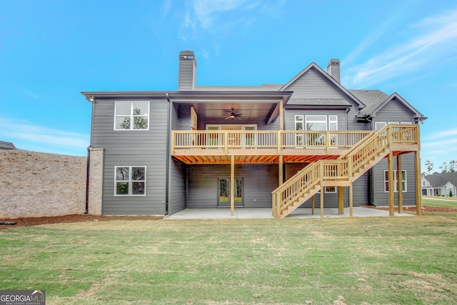 back of house with a wooden deck, a patio area, ceiling fan, and a lawn