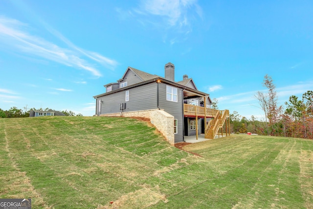 back of property with a lawn and a deck