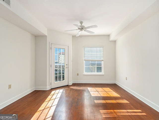 interior space with wood-type flooring, visible vents, and baseboards