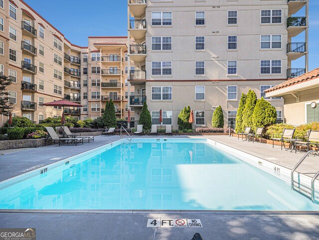 community pool with a patio area