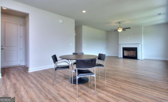 dining space featuring ceiling fan and light hardwood / wood-style floors