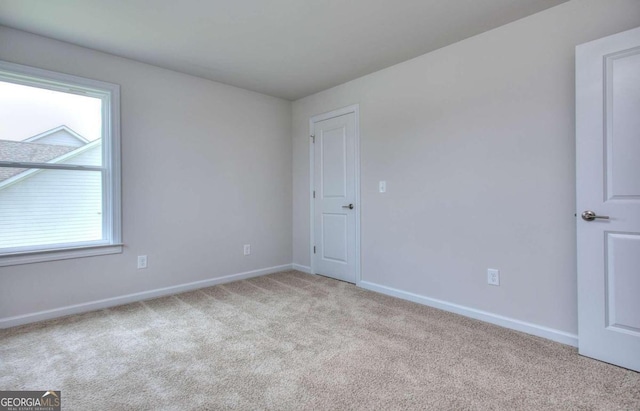 unfurnished room with light carpet