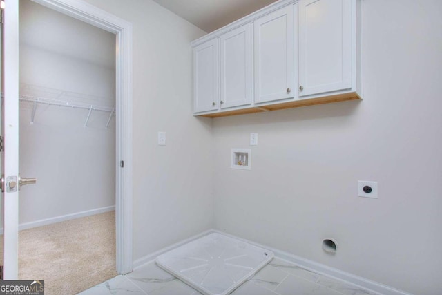 laundry room featuring hookup for a washing machine, electric dryer hookup, light colored carpet, and cabinets