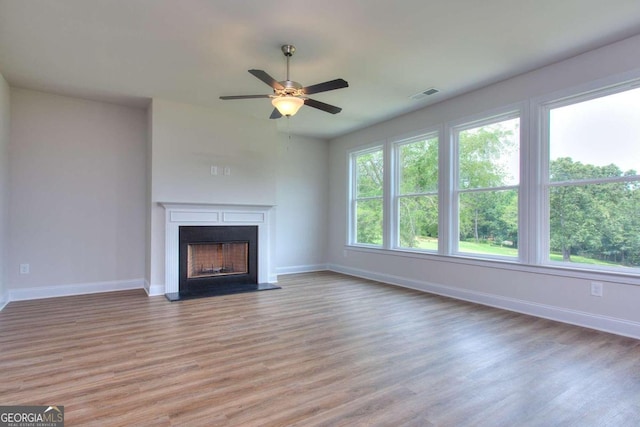 unfurnished living room with light hardwood / wood-style floors and ceiling fan