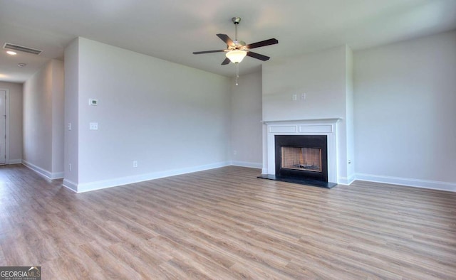 unfurnished living room with ceiling fan and light hardwood / wood-style flooring