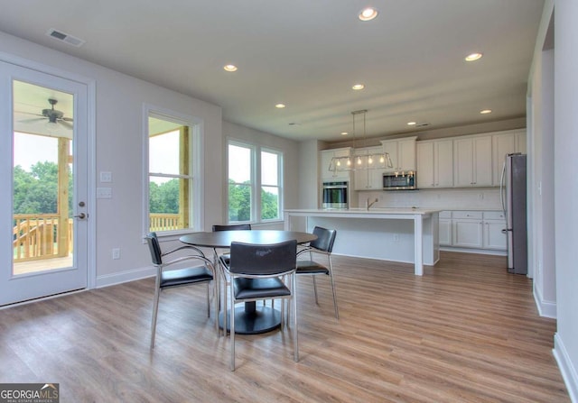 dining area featuring ceiling fan and light hardwood / wood-style floors