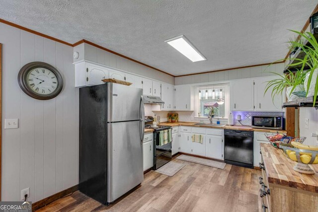 kitchen featuring white cabinetry, stainless steel appliances, wood counters, and light hardwood / wood-style flooring