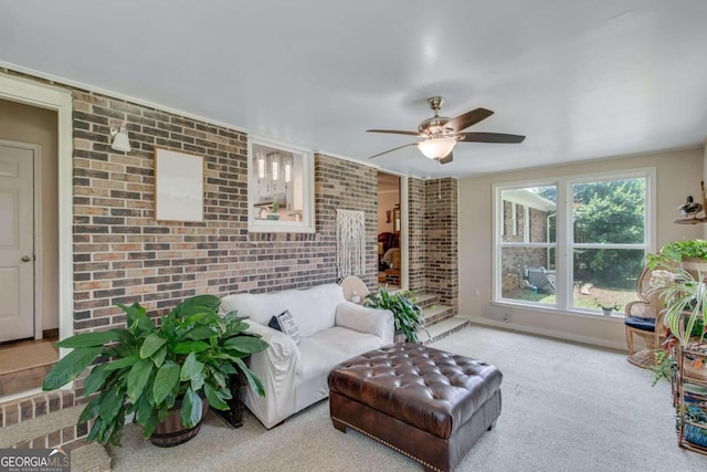 living room featuring brick wall, carpet, and ceiling fan