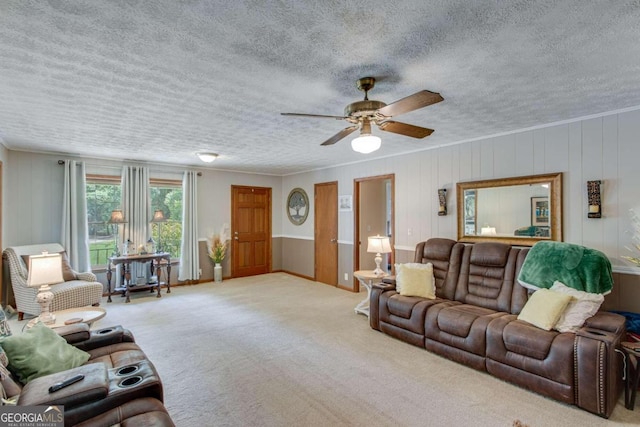 living room featuring ceiling fan, light carpet, and a textured ceiling