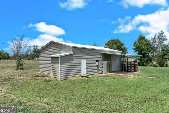 view of outbuilding featuring a lawn