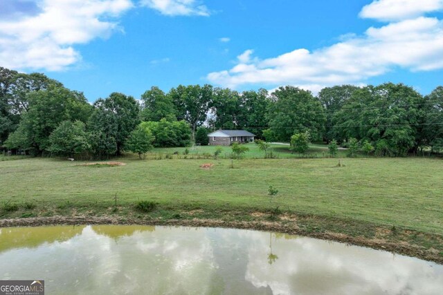 view of yard with a water view and a rural view