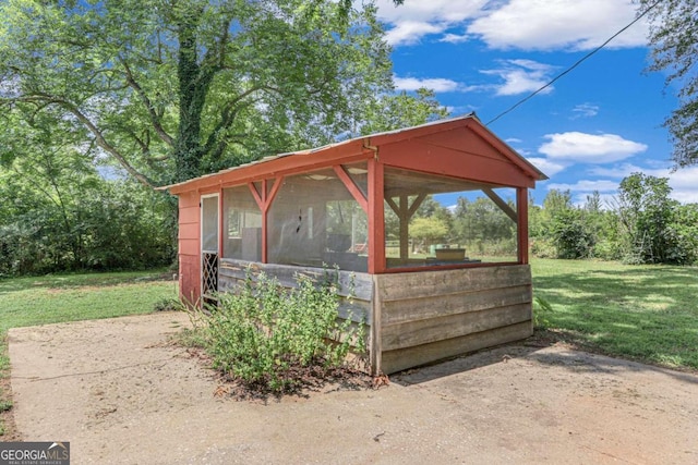 view of outdoor structure with a lawn