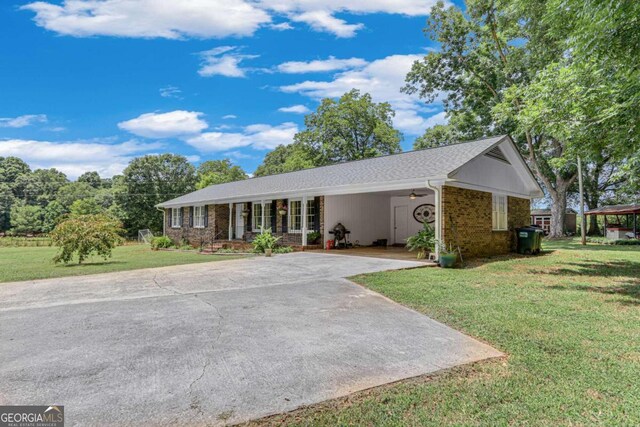 ranch-style house with a carport and a front lawn