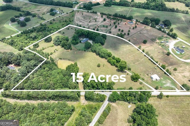 birds eye view of property featuring a rural view