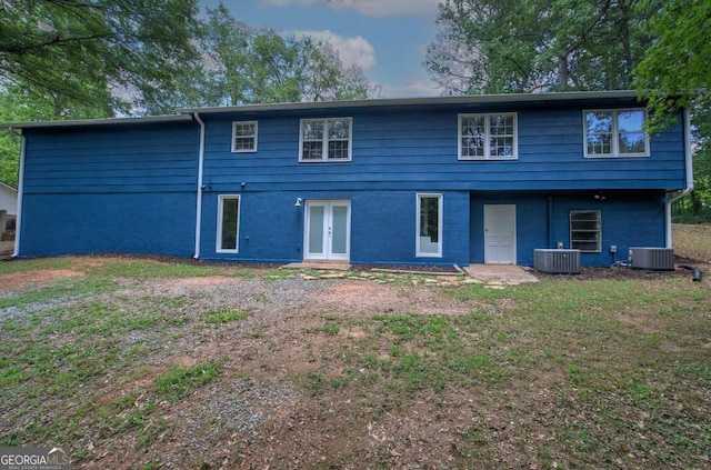 view of front of house with central AC unit and french doors