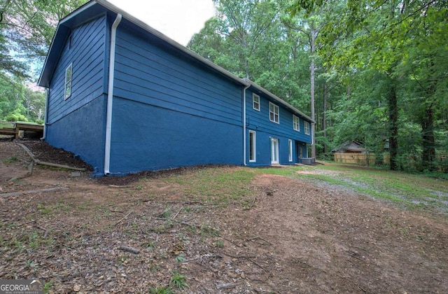 view of side of home featuring central air condition unit