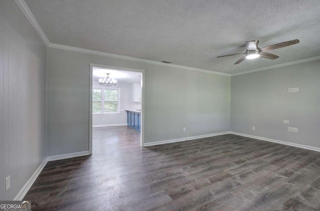 empty room with ceiling fan with notable chandelier, dark hardwood / wood-style flooring, and ornamental molding