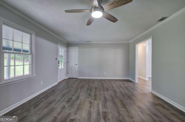 spare room with ceiling fan, a textured ceiling, dark hardwood / wood-style flooring, and crown molding