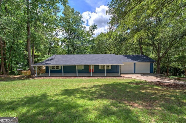 ranch-style house featuring a garage, covered porch, and a front yard