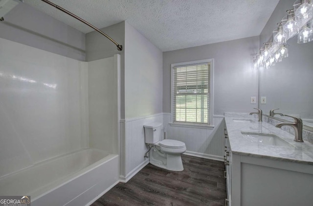 full bathroom featuring hardwood / wood-style flooring, shower / bath combination, a textured ceiling, and vanity