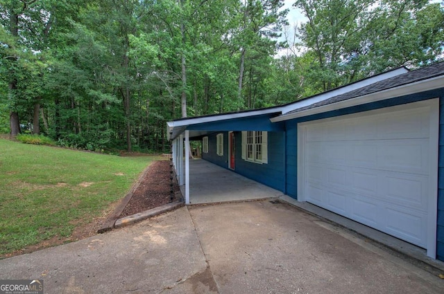 garage featuring a lawn and a carport