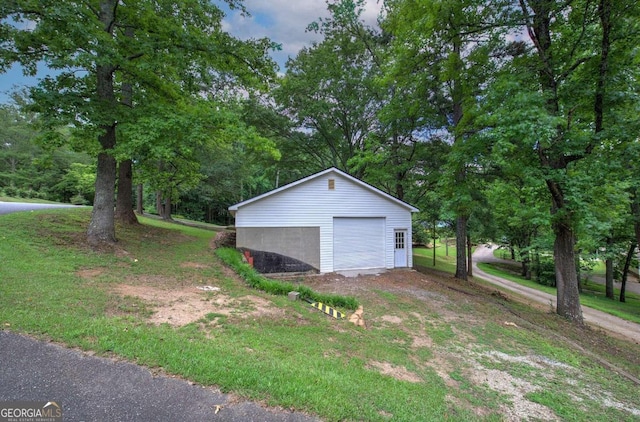 view of property exterior featuring an outdoor structure and a garage