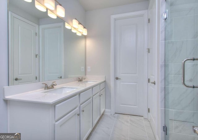 full bathroom featuring a stall shower, double vanity, a sink, and marble finish floor