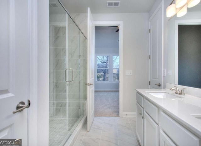 full bath with a shower stall, a sink, double vanity, visible vents, and marble finish floor