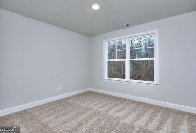 carpeted spare room with recessed lighting, visible vents, and baseboards