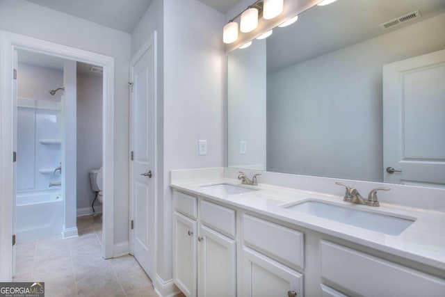 full bathroom featuring tile patterned floors, visible vents, double vanity, and a sink