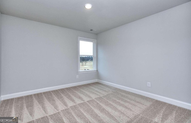 spare room featuring baseboards, visible vents, light colored carpet, and recessed lighting
