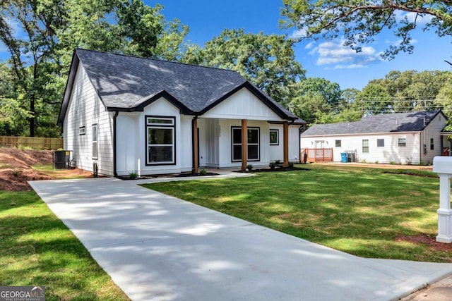 modern inspired farmhouse with a front yard and central air condition unit