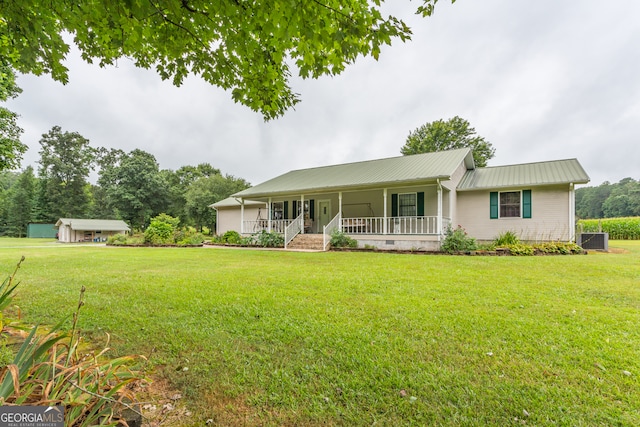 ranch-style home with covered porch and a front lawn