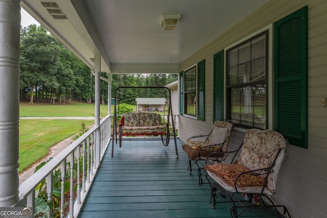 wooden terrace featuring a yard